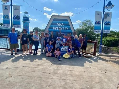 BMS families in front of a SeaWorld sign